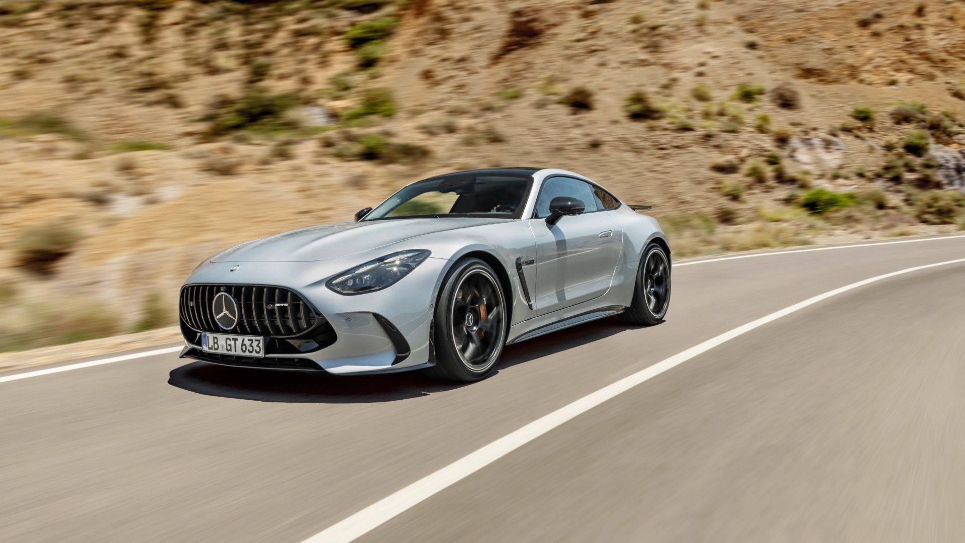 Gunmetal grey Mercedes AMG GT 63 driving on a road