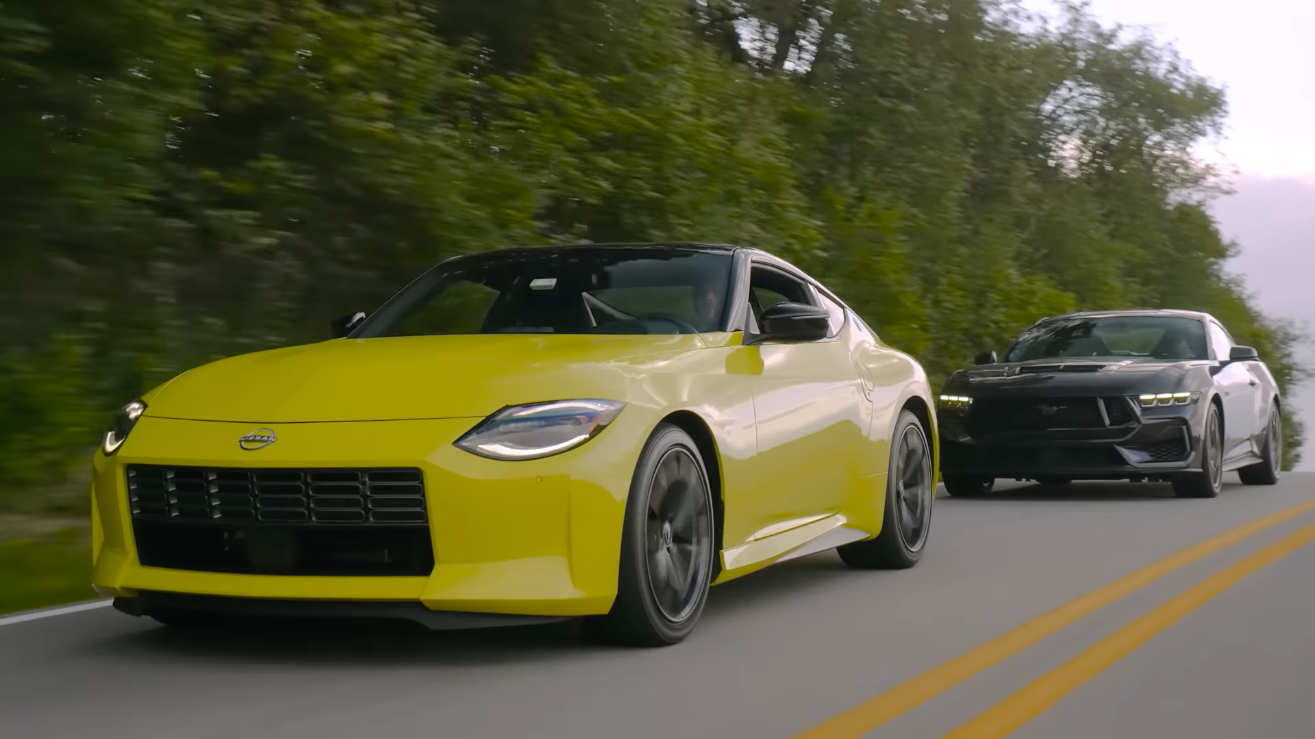 2024 Ford Mustang GT driving behind 2023 Nissan Z