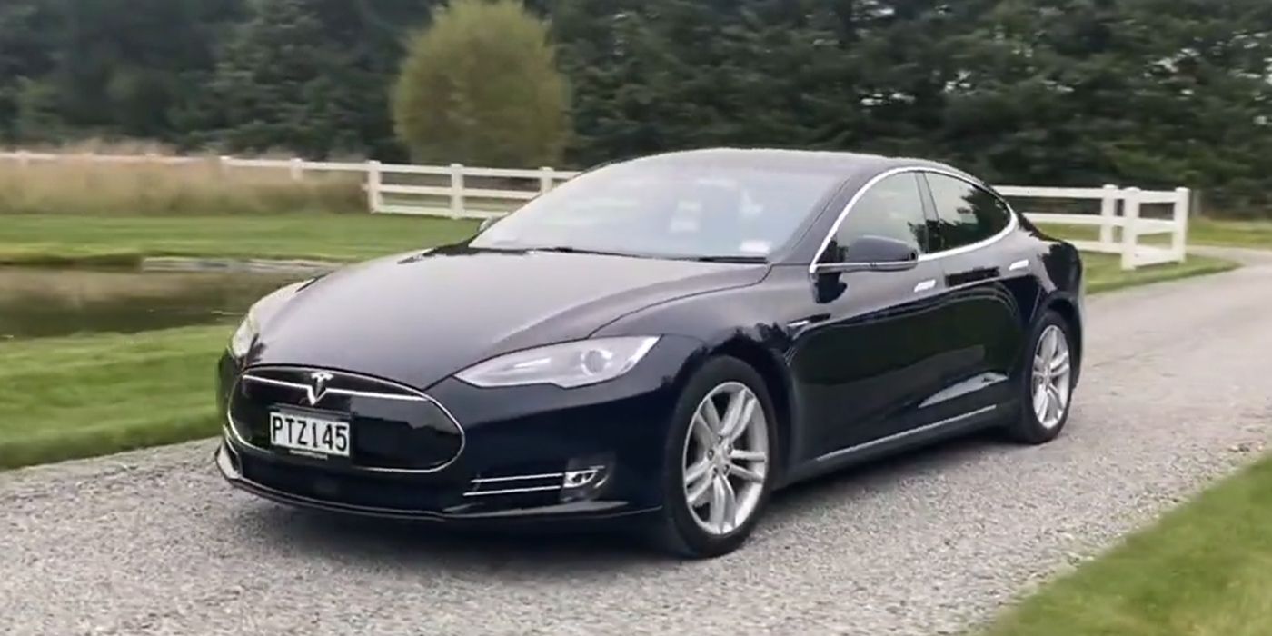 black 2015 Tesla Model S 60 parked on gravel driveway