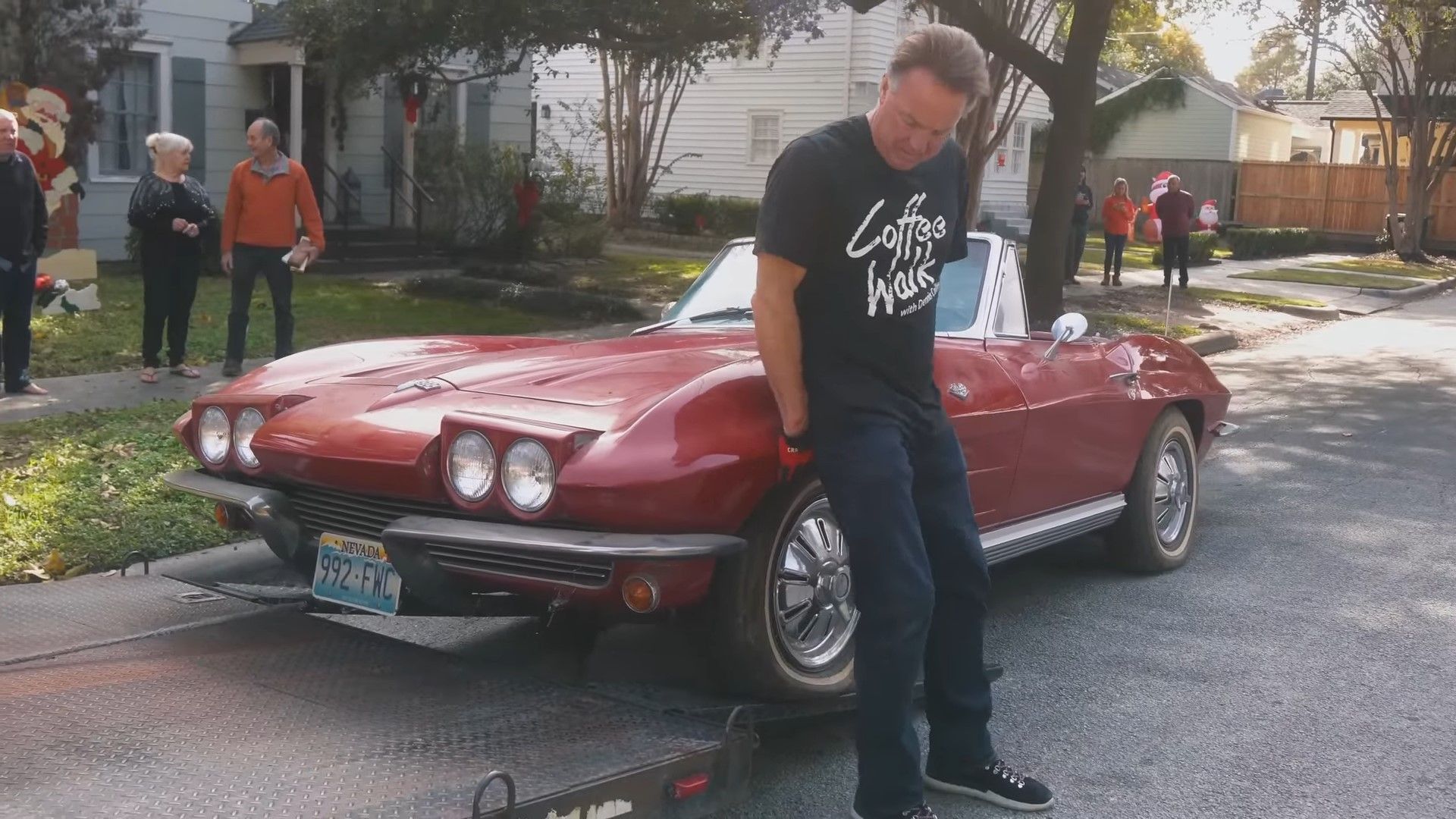 A red 1964 C2 Chevrolet Corvette Stingray Convertible w Dennis Collins being loaded onto a trailer
