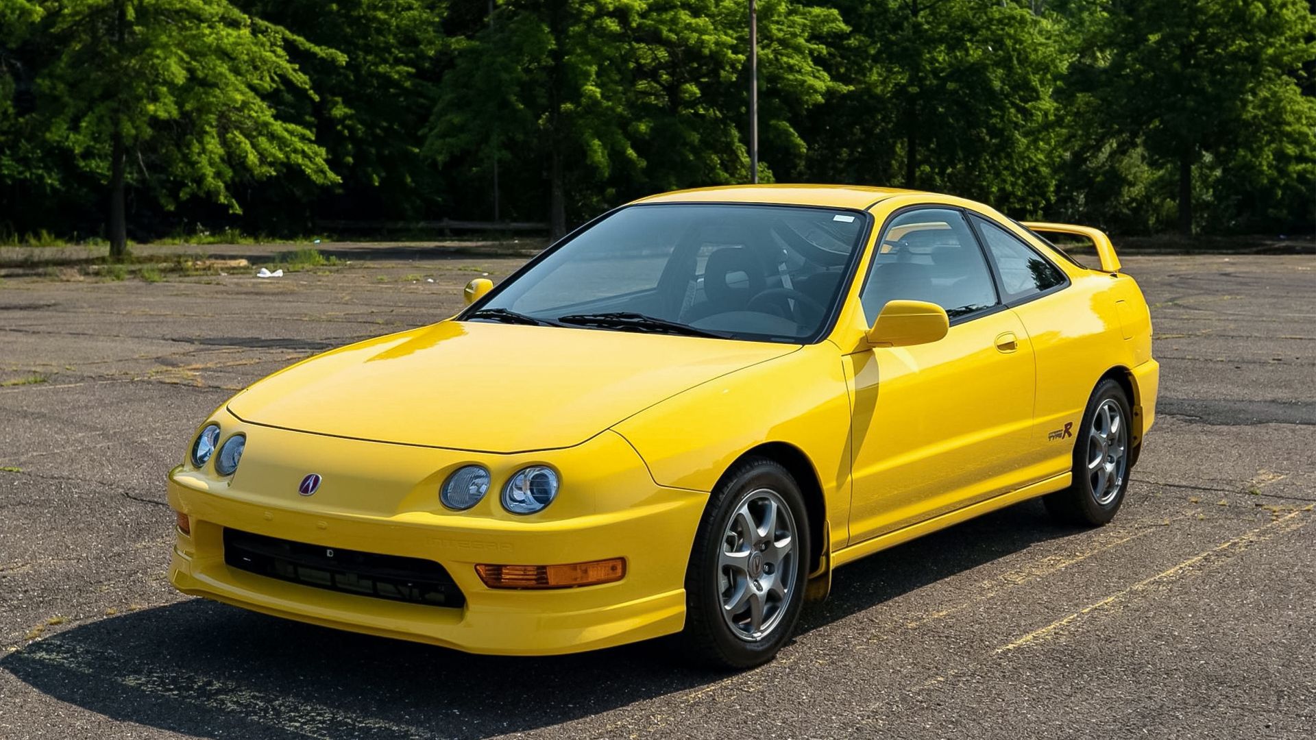A yellow 2000 Acura Integra Type R parked oustide