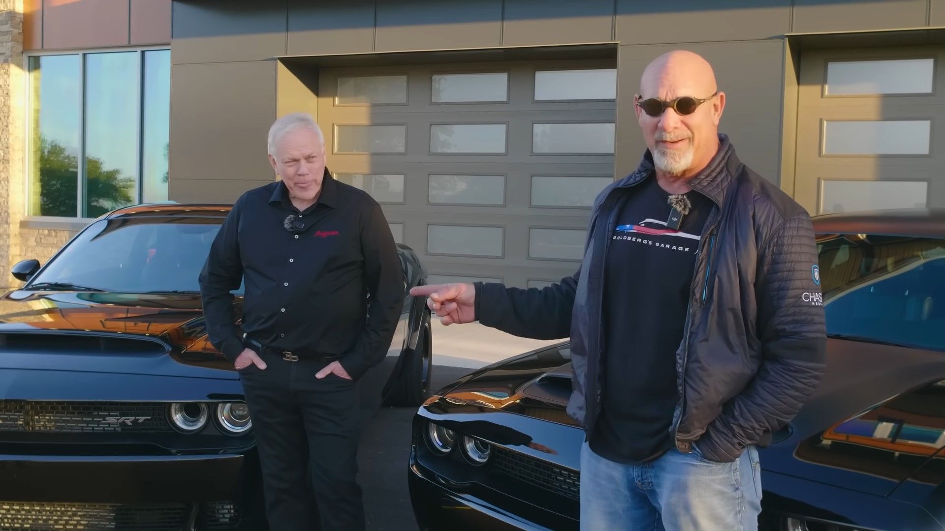 A black 2018 Dodge Chalenger Demon and a black 2023 Dodge Challenger Demon 170 with Bill Goldberg and Craig Jackson