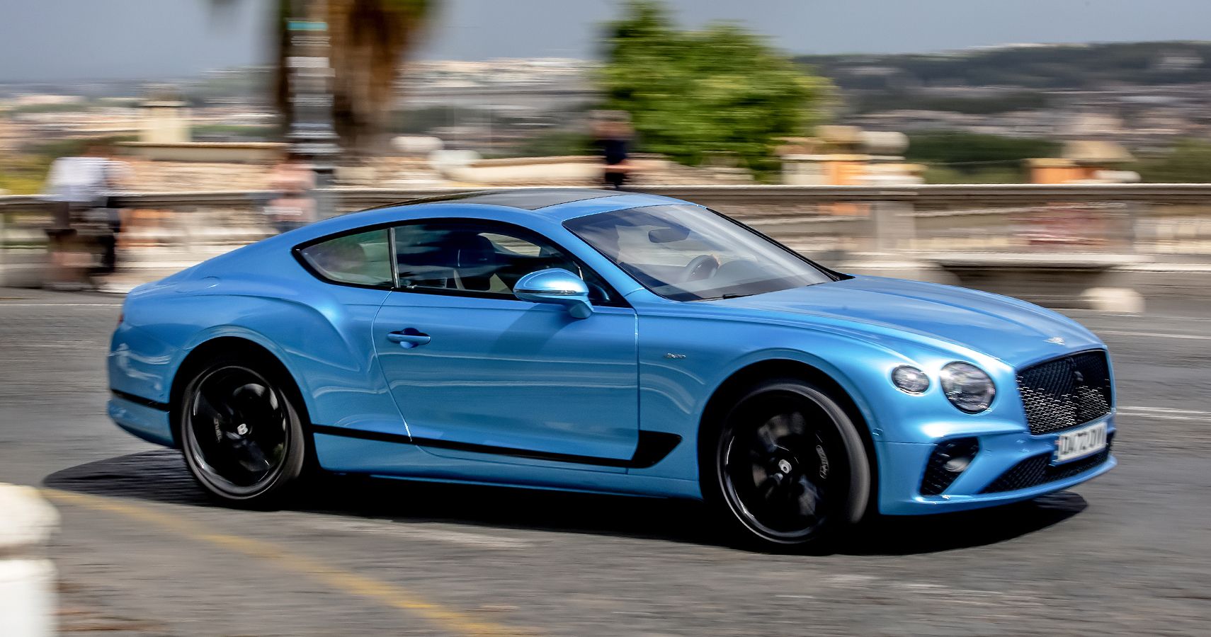 Blue Bentley Continental GT blue driving right profile