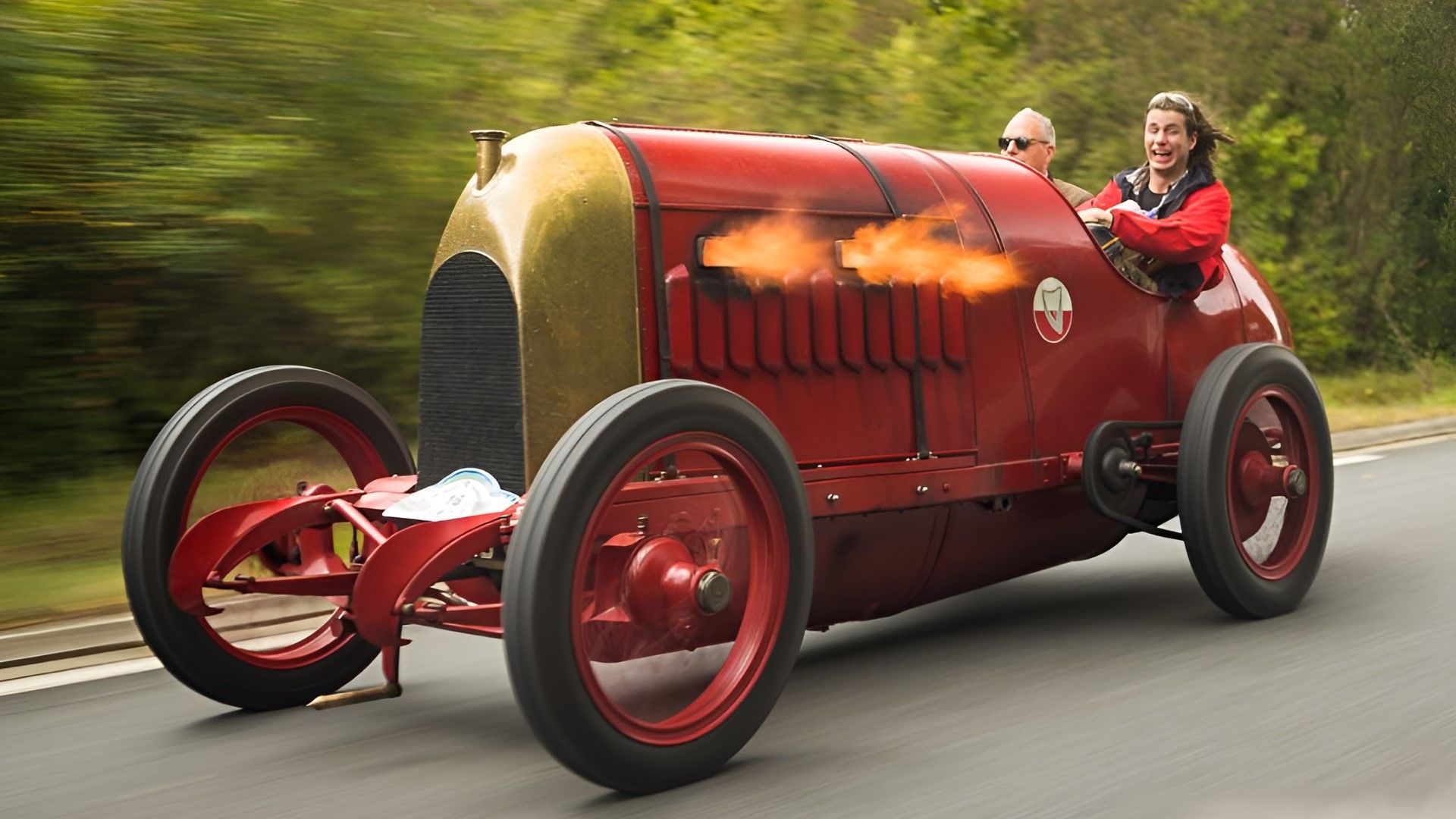 A red and gold 1911 Fiat S76 Beast of Turin spitting flames front quarter rolling shot