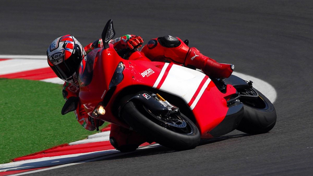 Ducati Desmosedici D16RR cornering on a racetrack hd wallpaper