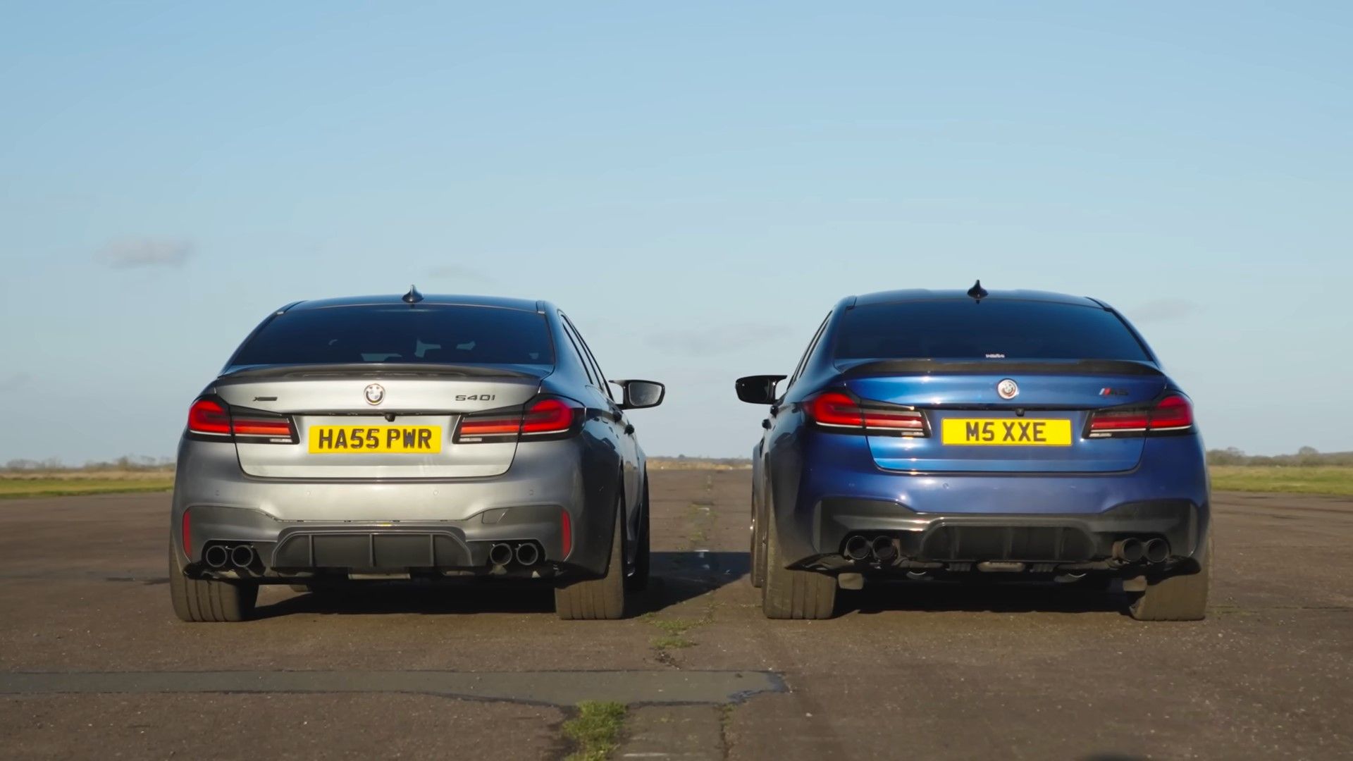 A blue 2020 F90 BMW M5 vs a silver 2020 BMW 540i xdrive rear shot