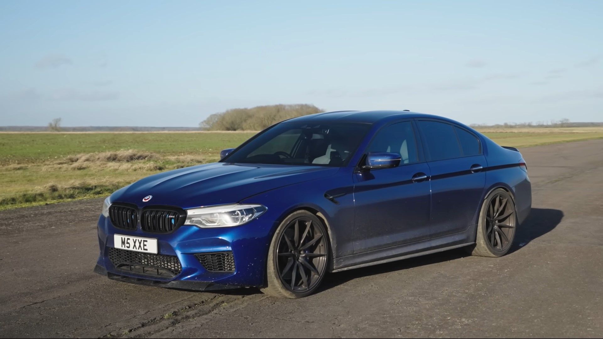 A blue 2020 F90 BMW M5 front quarter shot