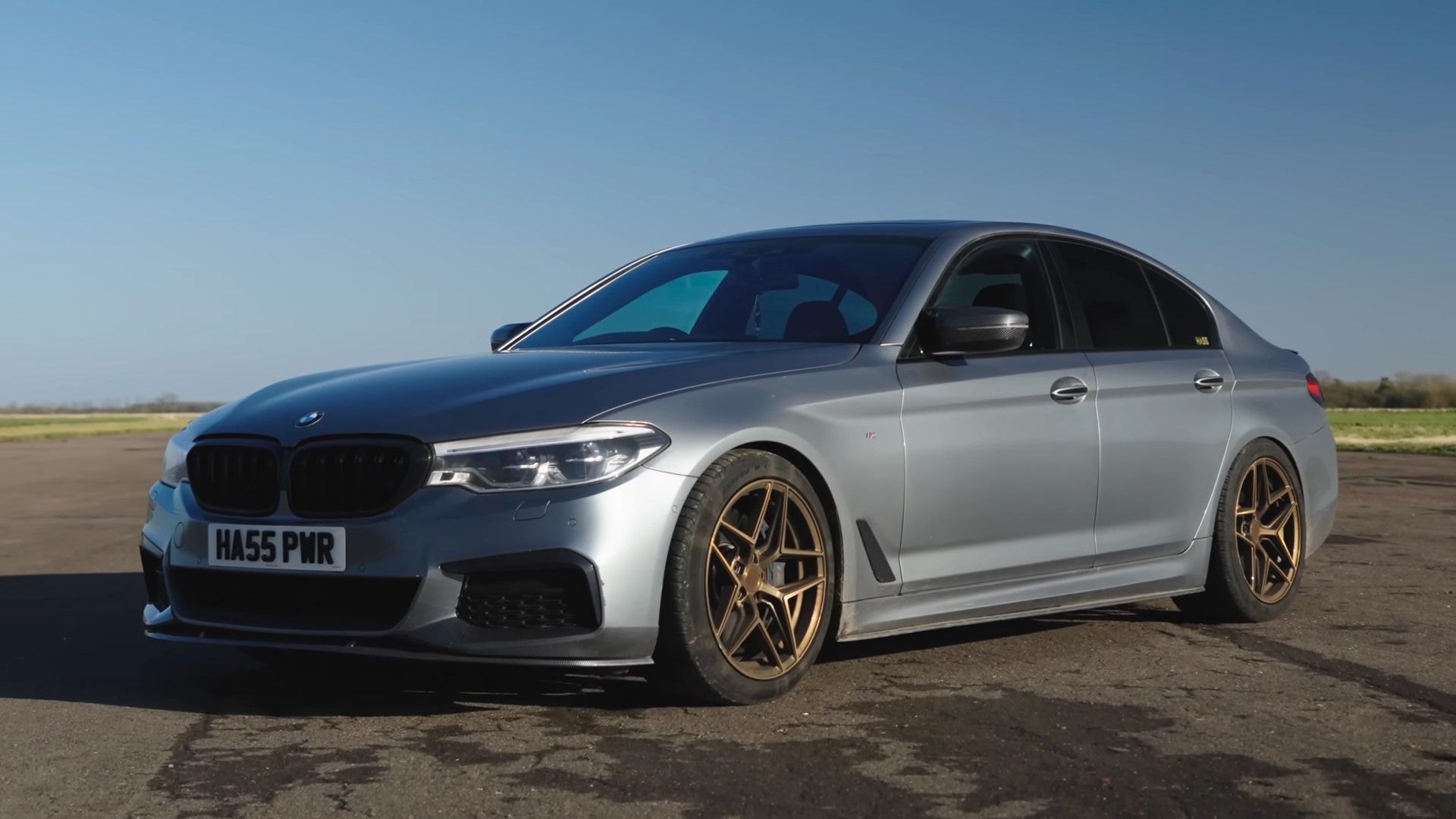 A silver 2020 BMW 540i xdrive front quarter shot