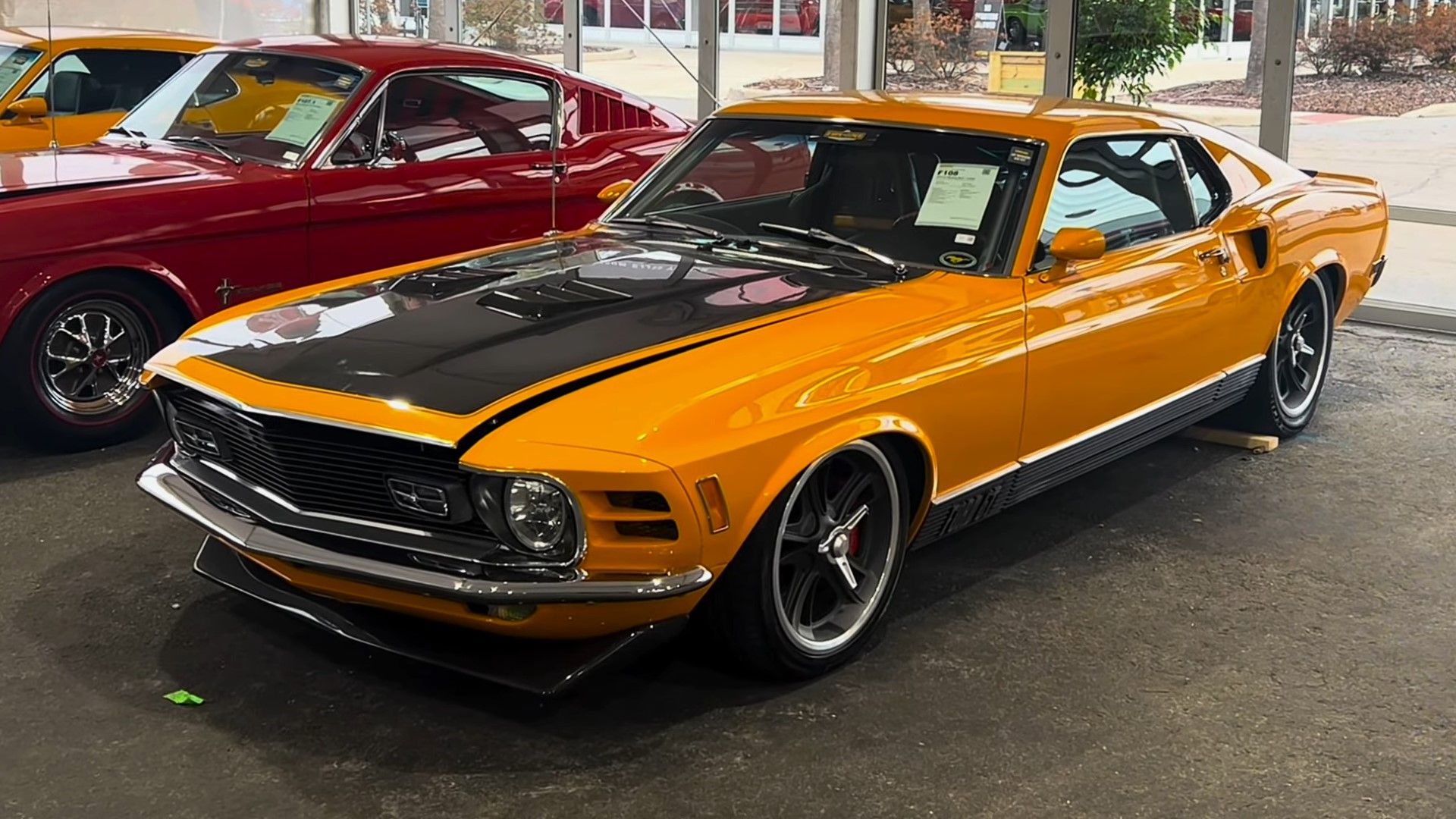 A yellow 1970 Ford Mustang Mach 1 mid-engine restomod front quarter shot