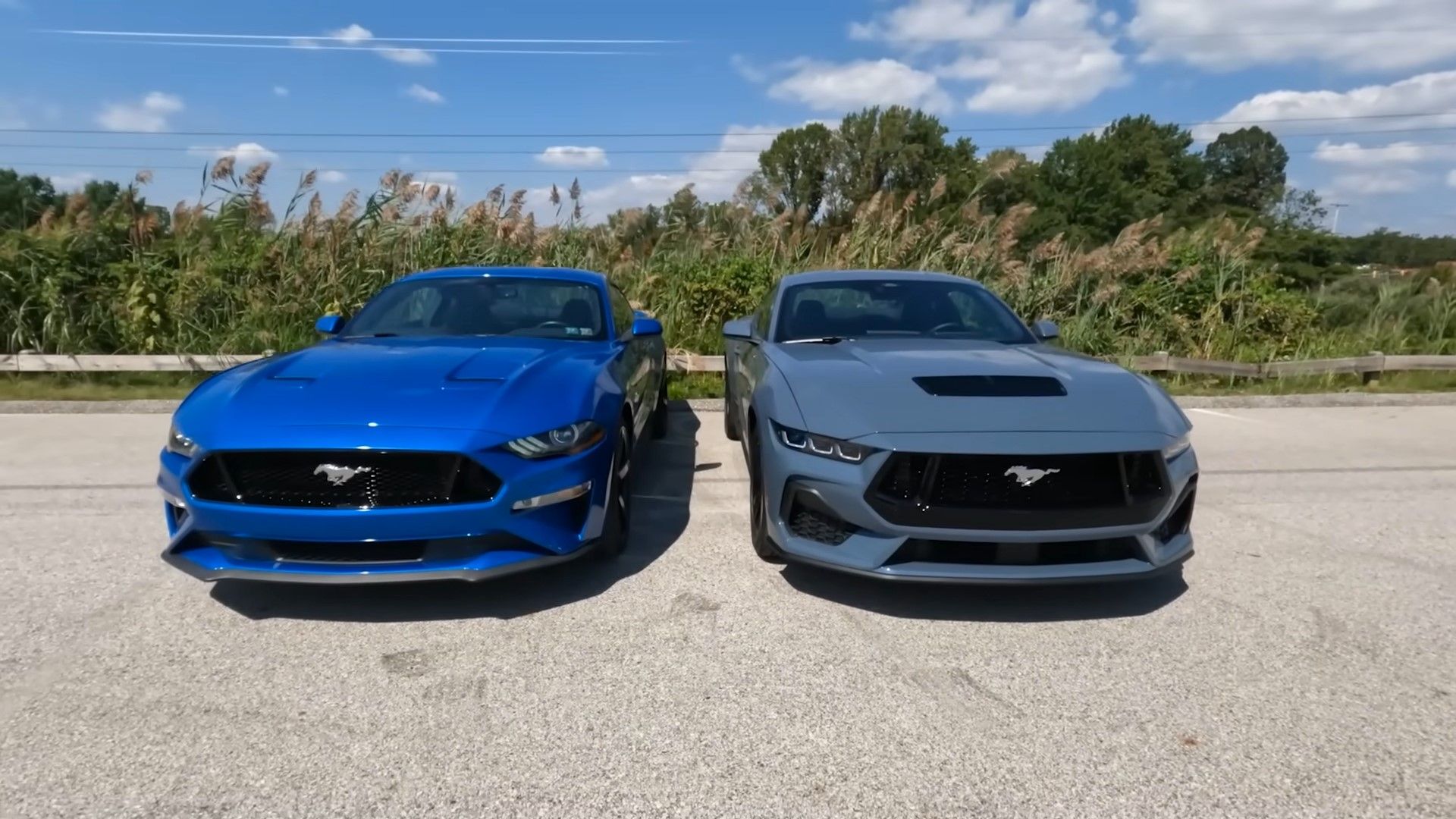A blue 2024 Ford Mustang GT S650 vs a dark blue 2019 Ford Mustang GT S550 front shot