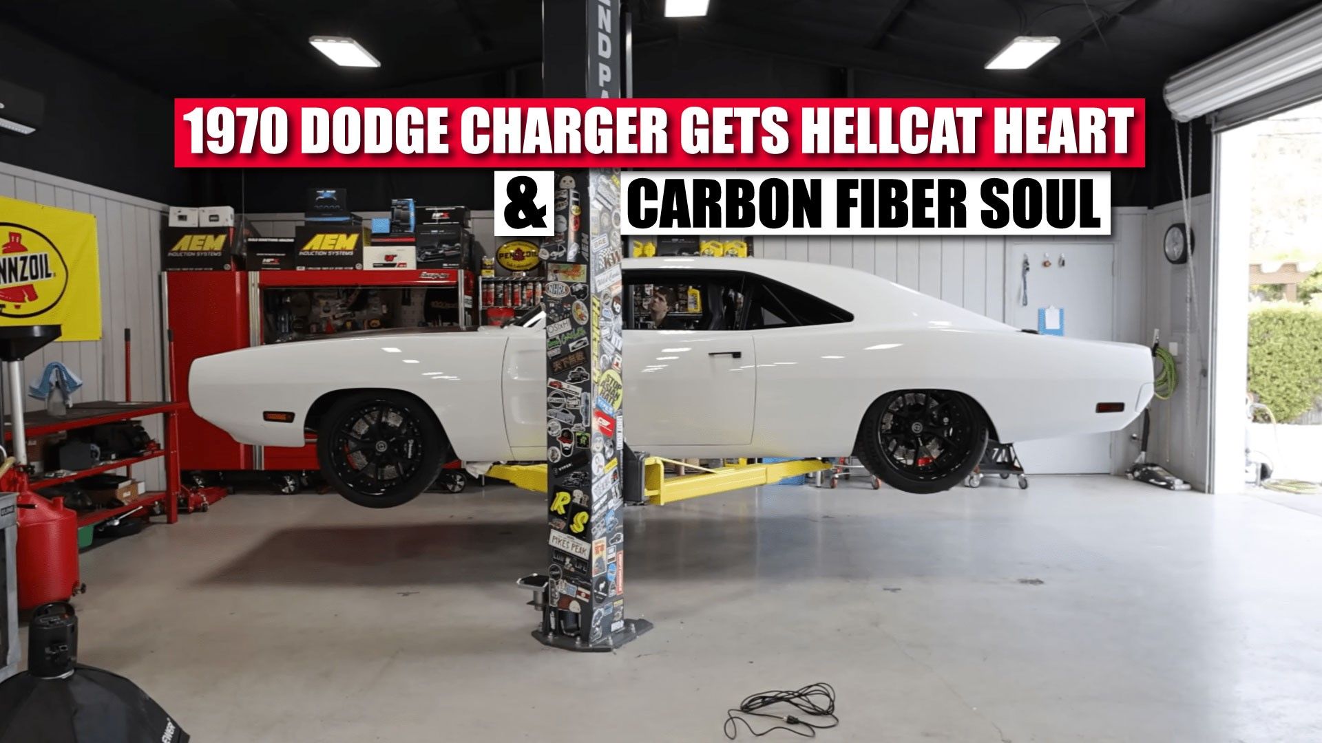 A white 1970 Dodge Charger R/T Ghost by SpeedKore on a lift side shot
