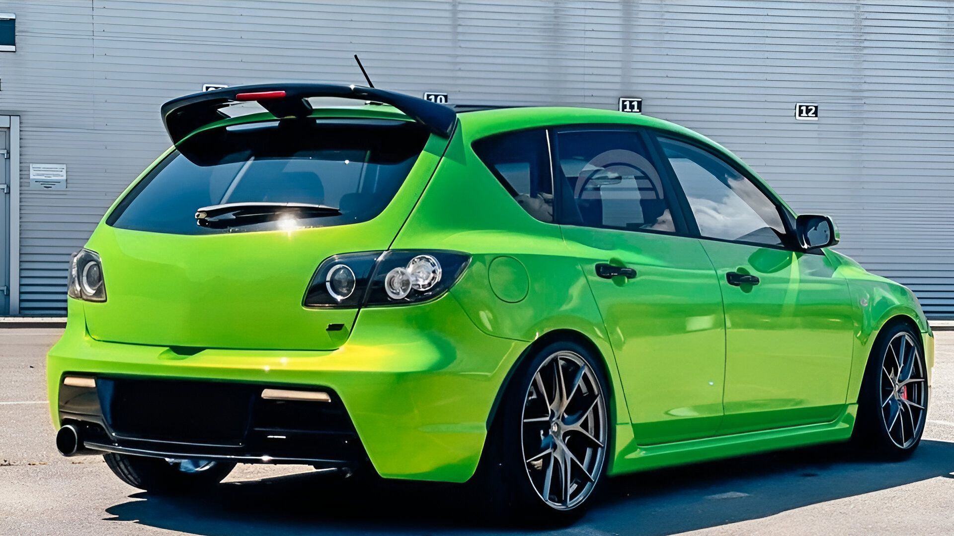 green 2007 Mazda Mazda3 with a bodykit  parked