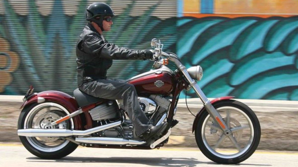 2008 Harley-Davidson Rocker accelerating on the road, side profile view