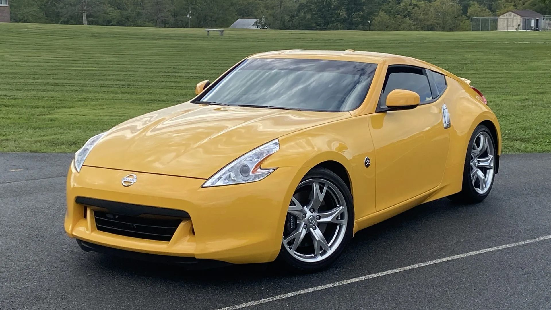 yellow 2009 Nissan 370Z Touring Sport parked
