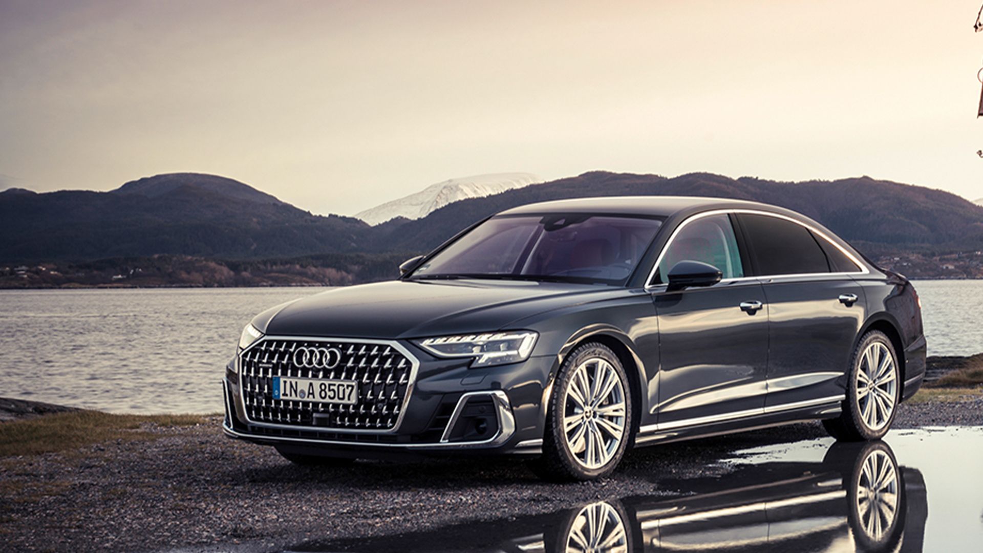 black 2024 Audi A8 L parked near a lake 