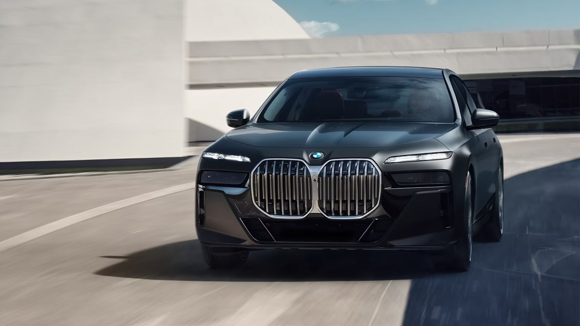 black 2024 BMW 7 Series driving on the road