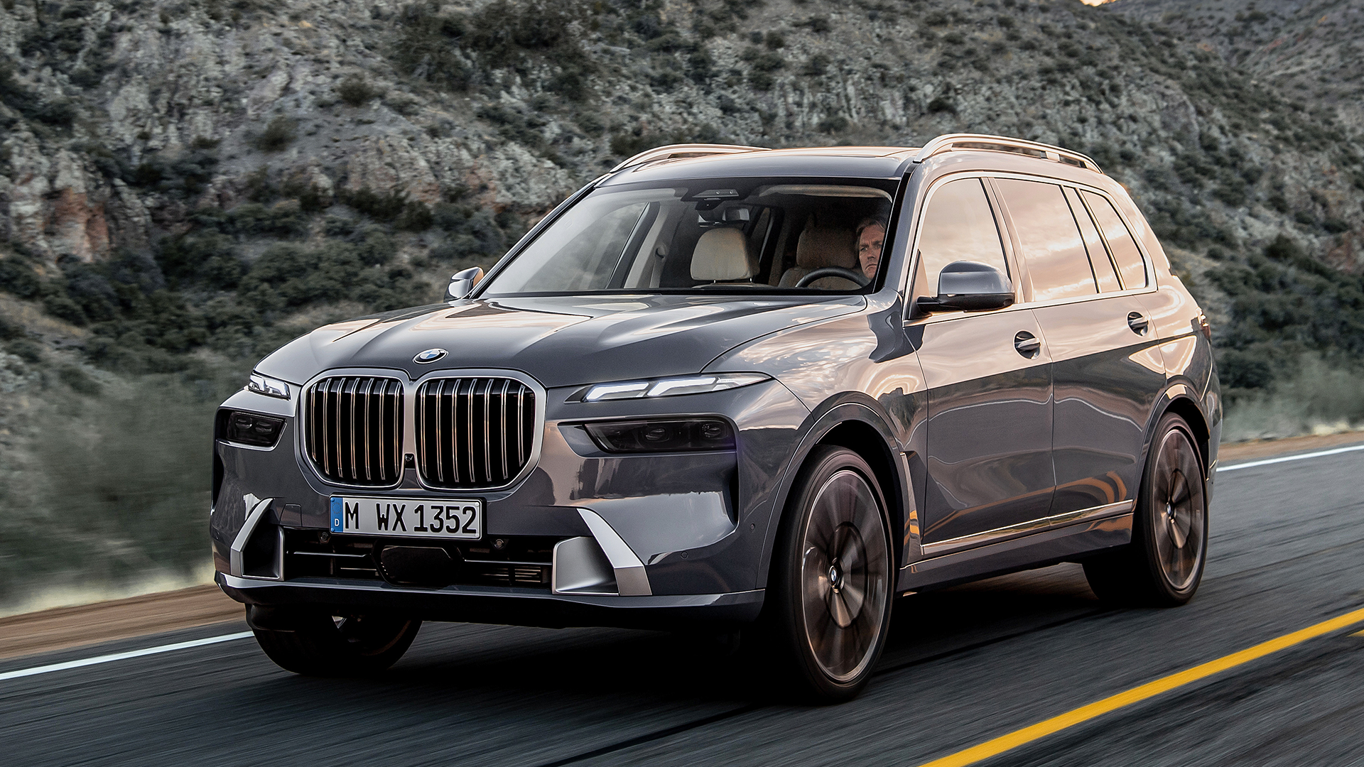 silver 2024 BMW X7 driving on the highway