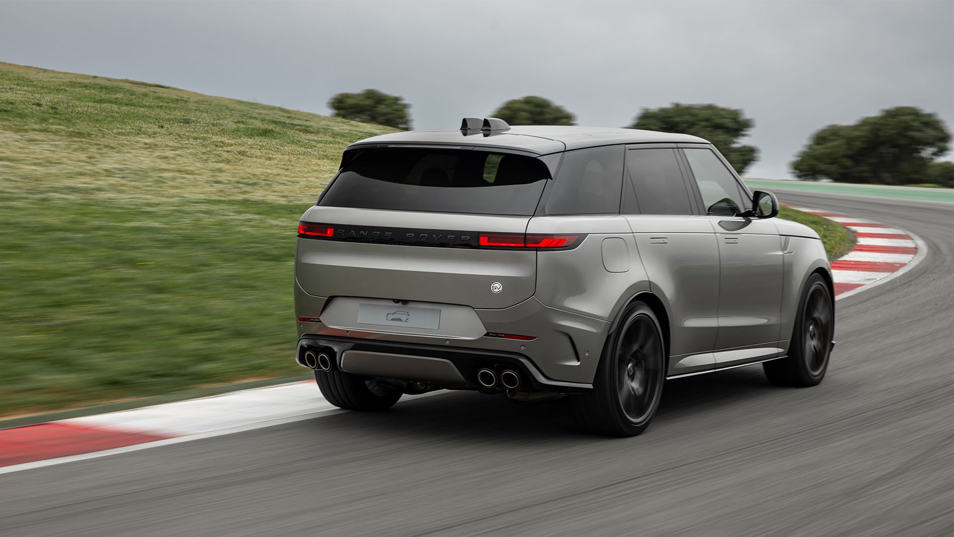 silver 2024 Range Rover Sport SV Edition One negotiating a corner driving