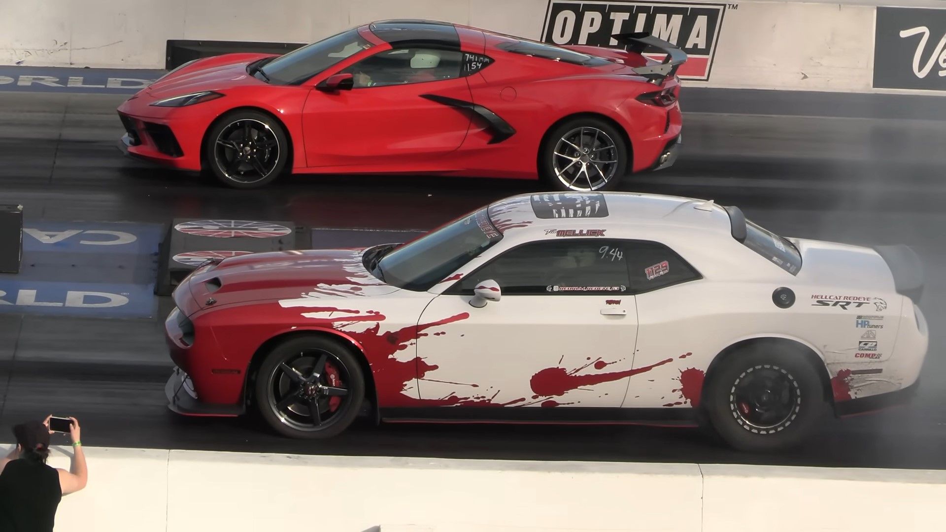 A red 2021 C8 Chevrolet Corvette Stingray vs a red and white 2022 Dodge Challenger Hellcat Redeye drag racing side shot 