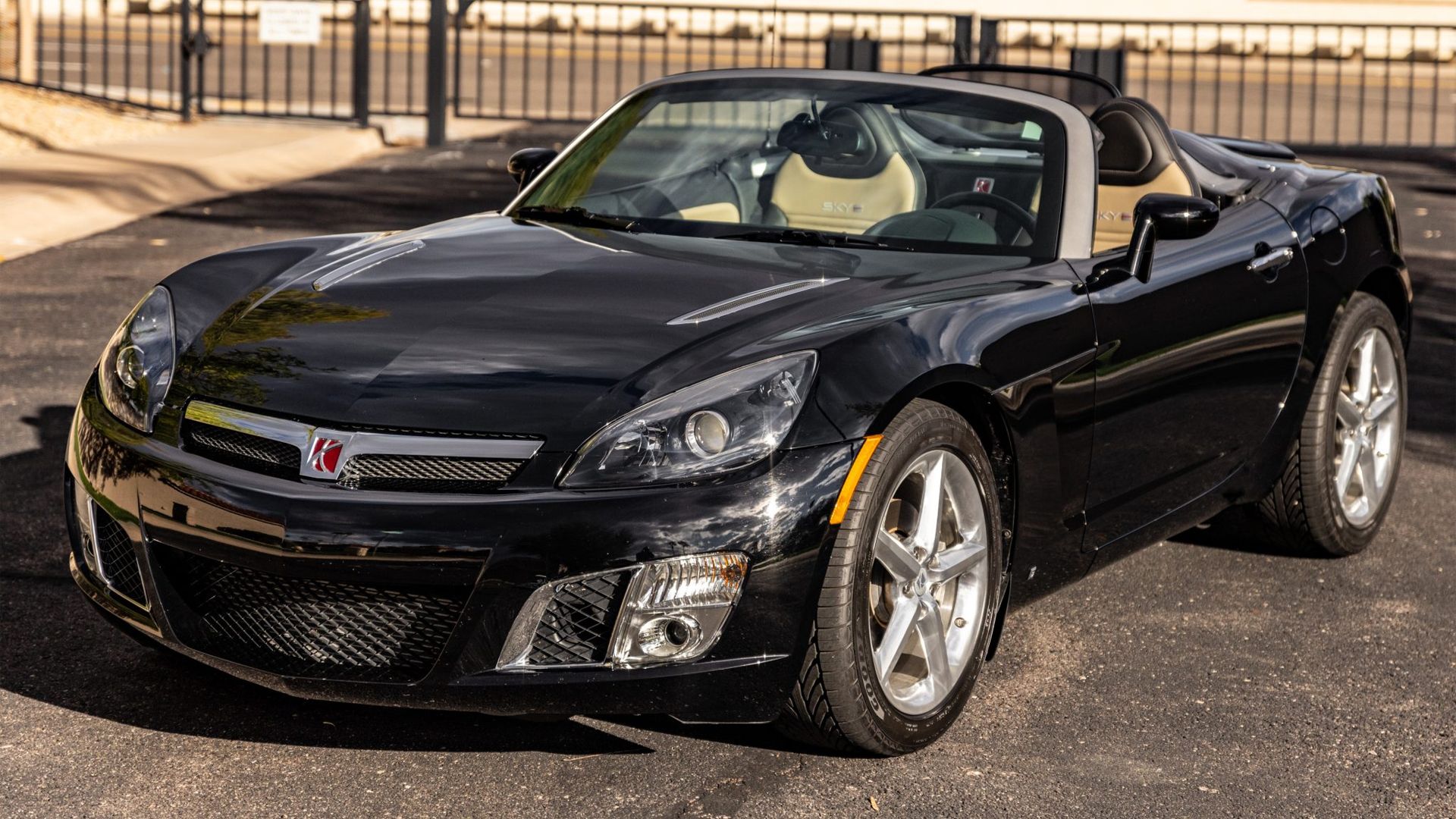 black 2008 Saturn Sky Red Line parked roof down