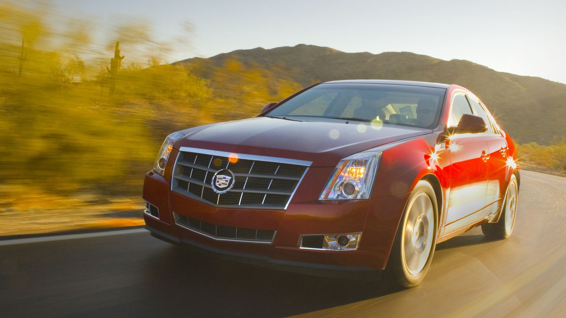 red 2010 Cadillac CTS driving