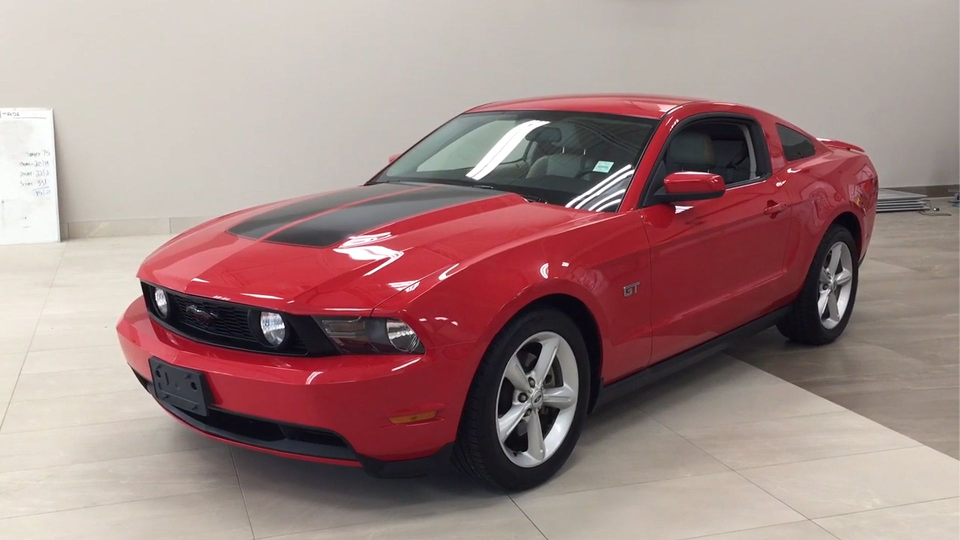 red 2010 Ford Mustang GT parked indoors