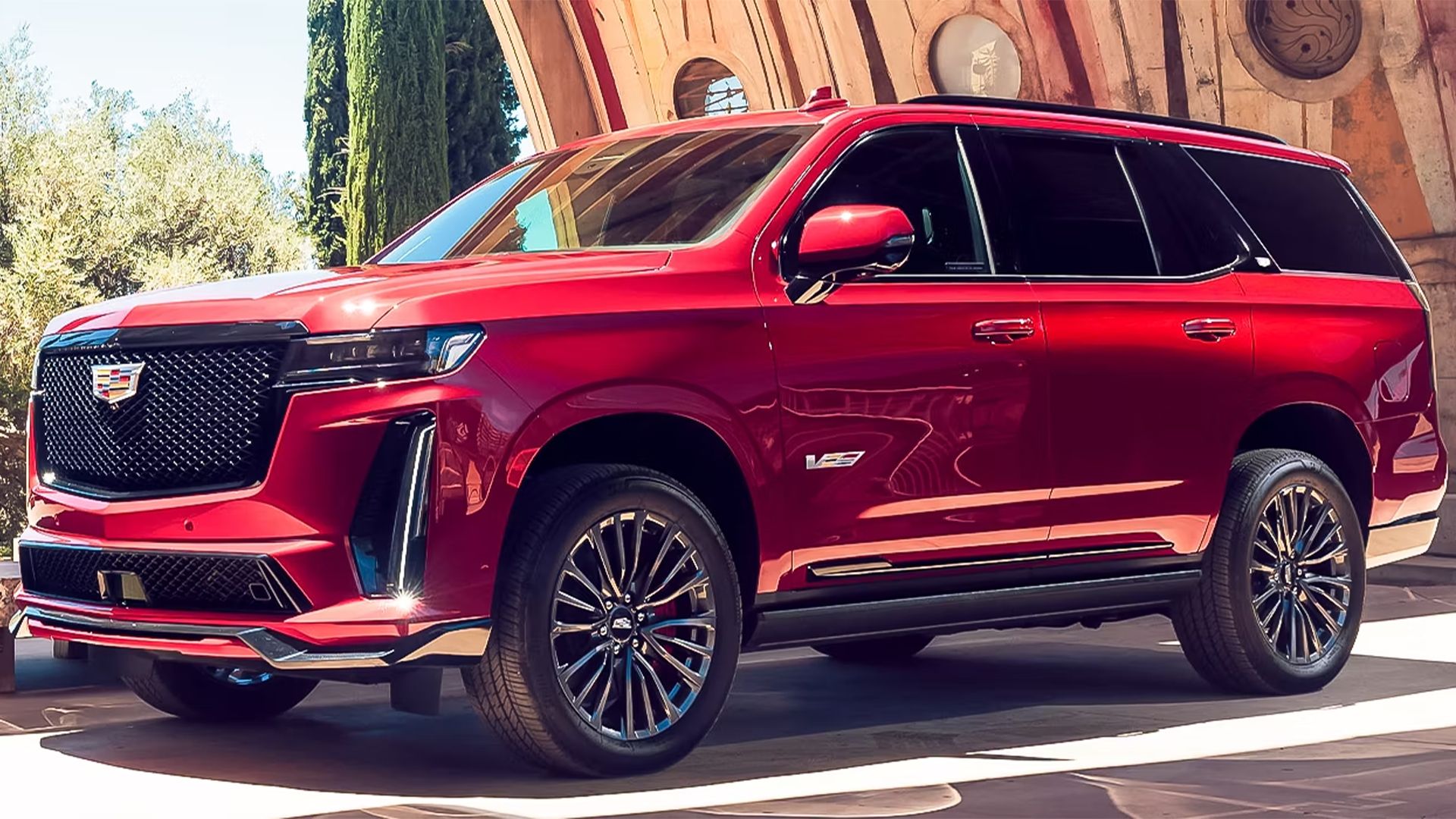 red Cadillac Escalade-V ESV SUV parked under bridge