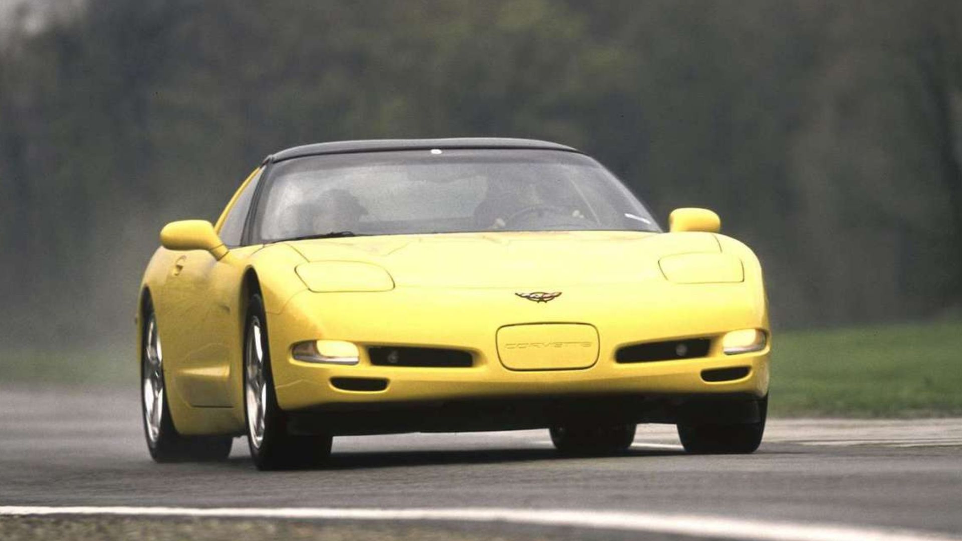 Corvette C5, front profile view on road from distance