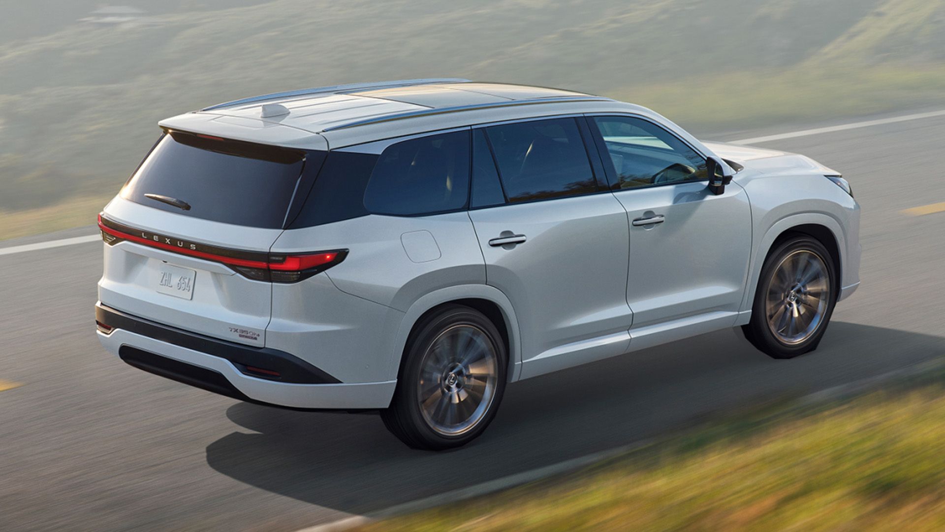 White 2024 Lexus TX 550h Luxury driving