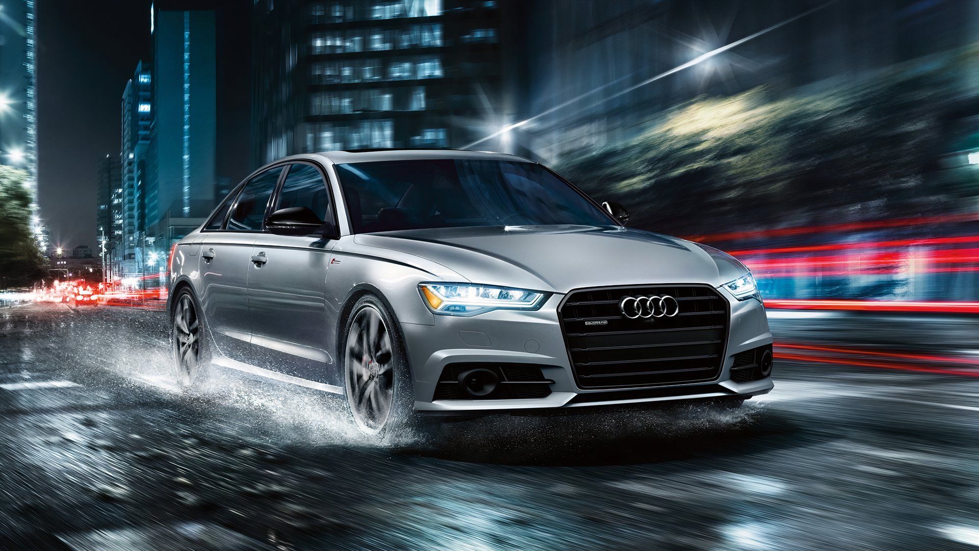 2017 Audi A6 dirigindo em estrada molhada à noite