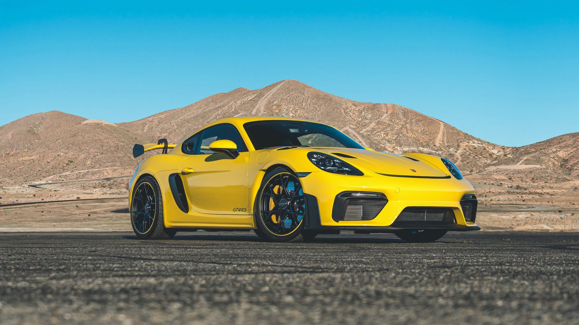 Racing Yellow 718 Cayman GT4 RS parked