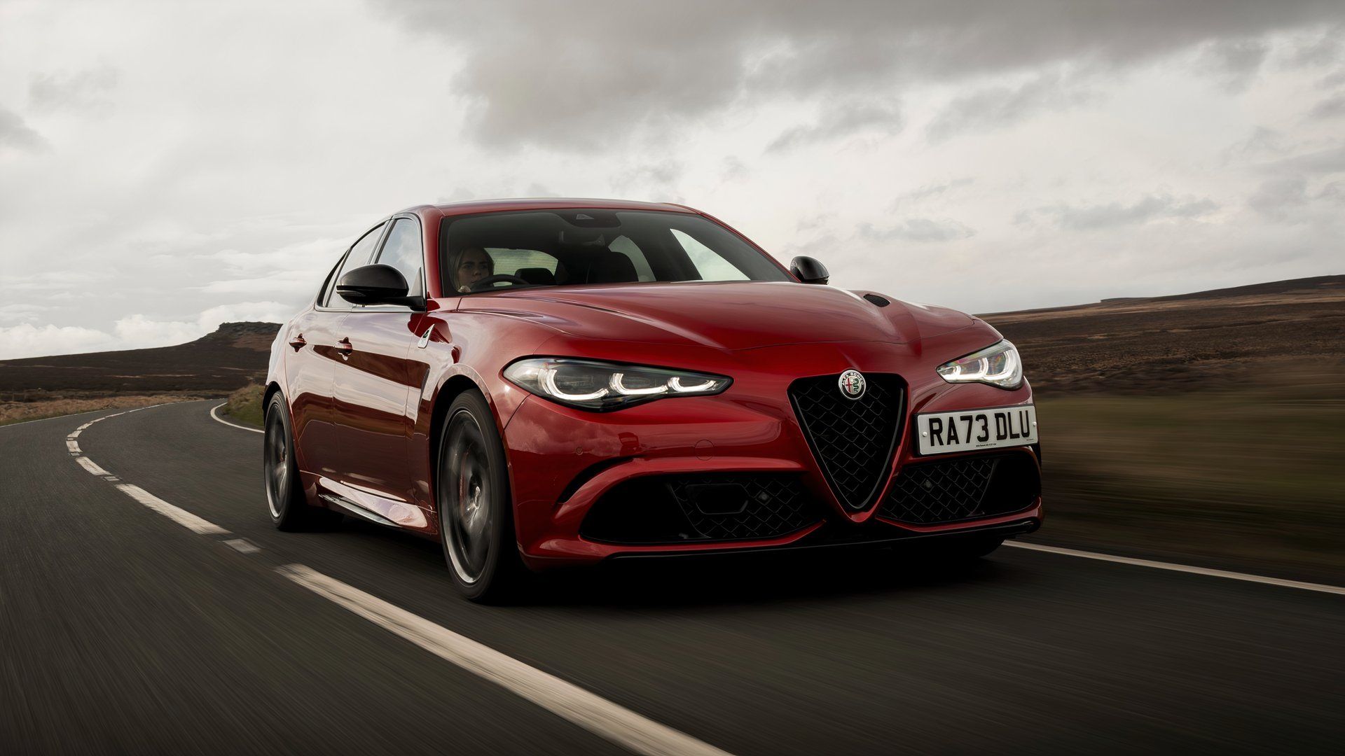 Red Alfa Romeo Giulia Quadrifoglio drives on the street